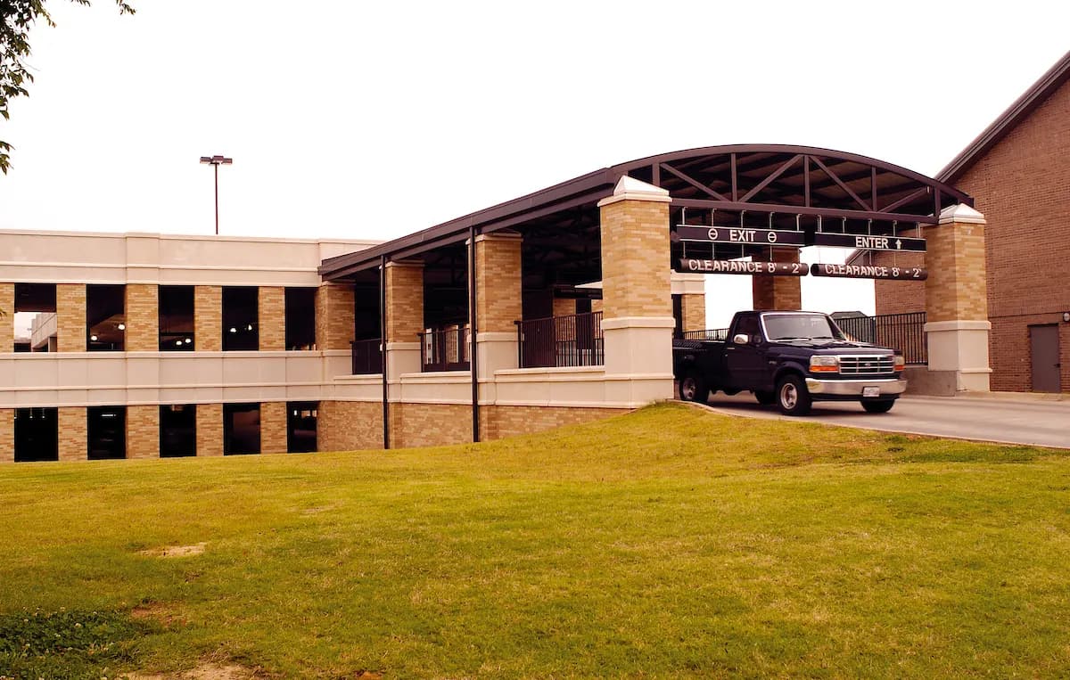 The entrance to a multi-storey parking garage on the Arkansas State University campus, with a height clearance sign