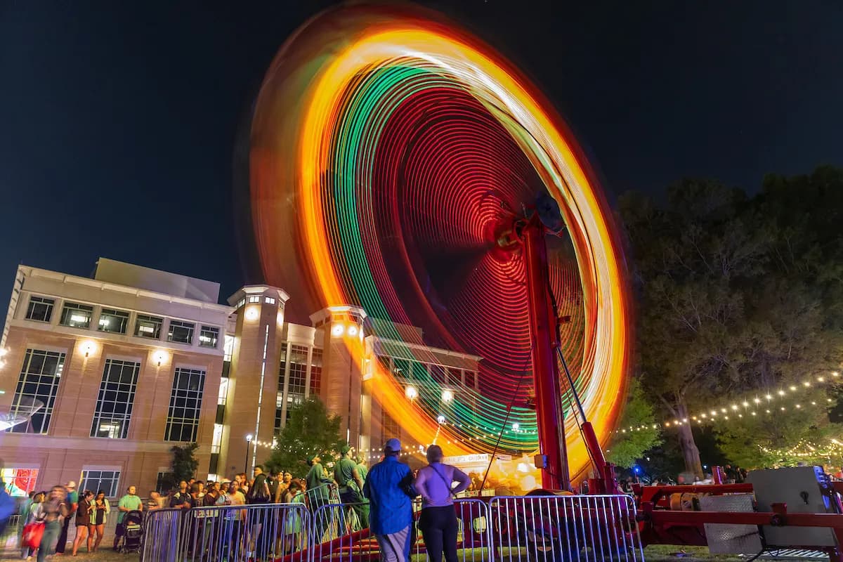 A lit fairground ride at an evening event on the A-State campus