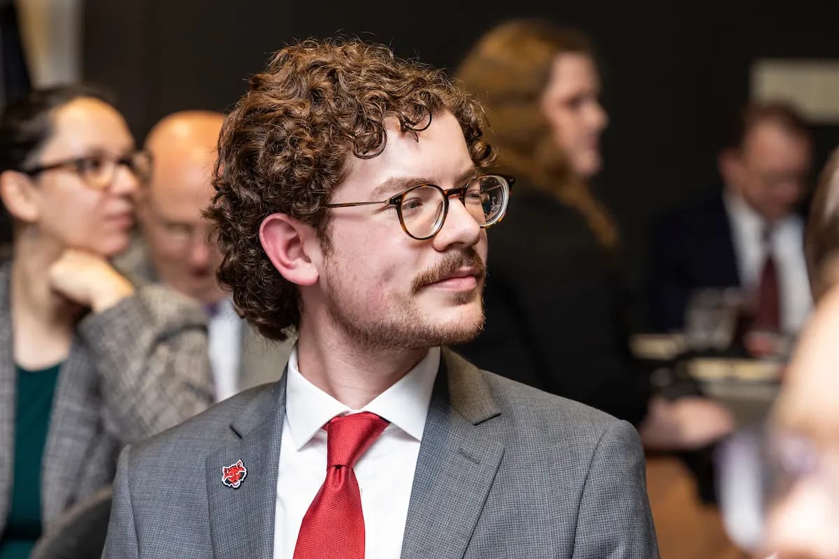 Wilson Award ceremony at Arkansas State University, a student receiving a Red Wolves pin