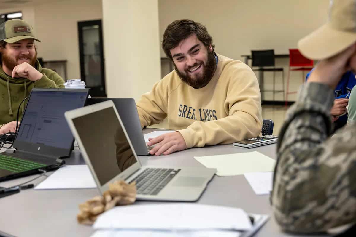 A-State students working together on laptops during a study session