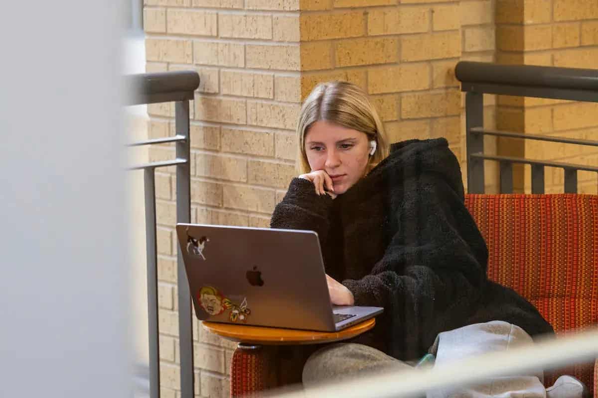 A student working on a laptop indoors