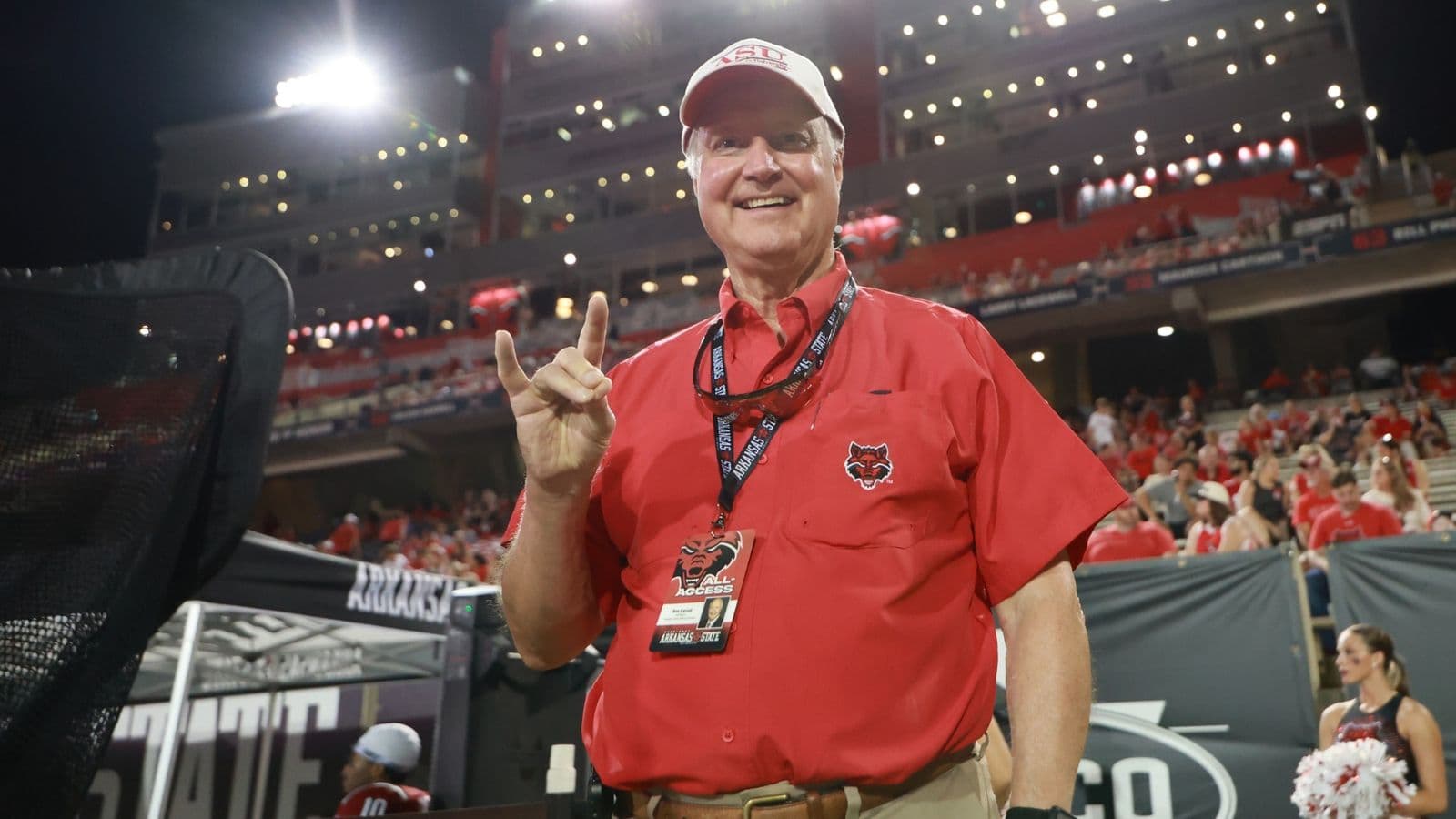 Ron Carroll giving the “Wolves Up” sign on the sideline at A-State’s football stadium