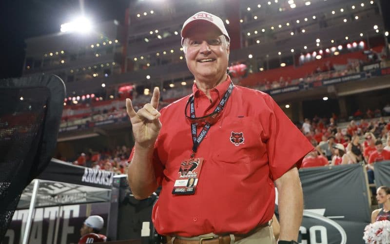Ron Carroll giving the “Wolves Up” sign on the sideline at A-State’s football stadium